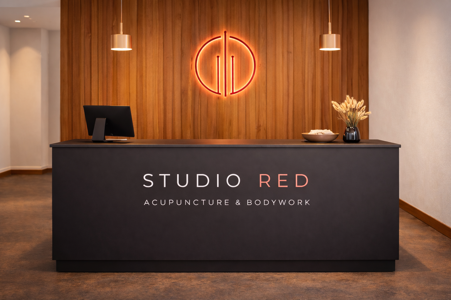 Studio Red Acupuncture reception area with wood feature wall and red logo in Hartland New Brunswick clinic
